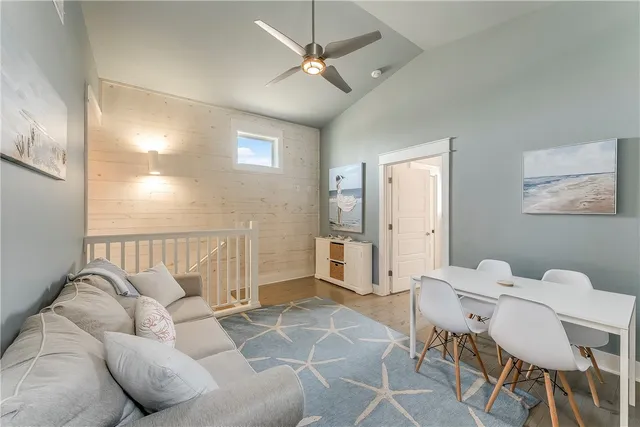 a living room with furniture a ceiling fan and a rug