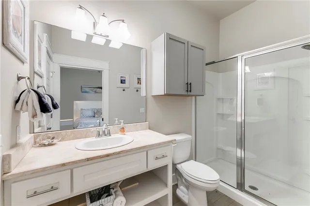 a bathroom with a sink toilet and shower