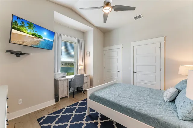 a bedroom with a bed and a flat screen tv