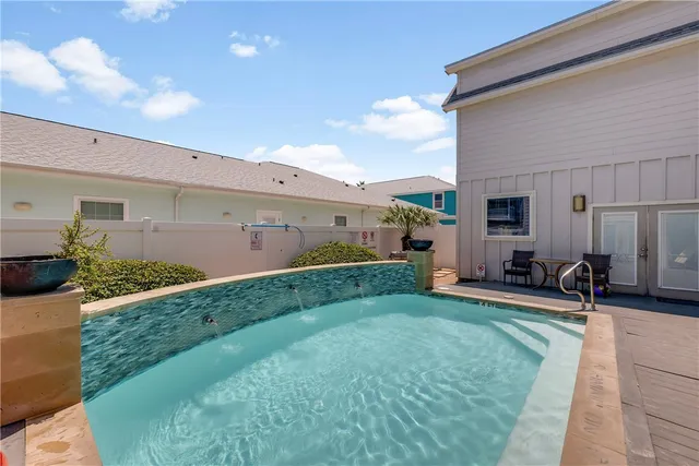 a view of a patio with table and chairs a barbeque with wooden fence