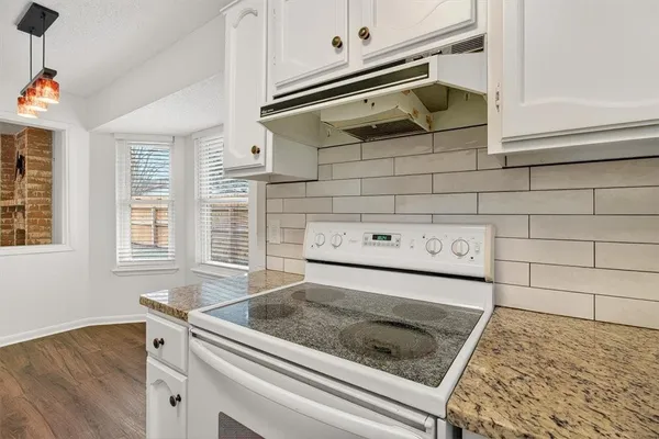 a stove top oven sitting inside of a kitchen