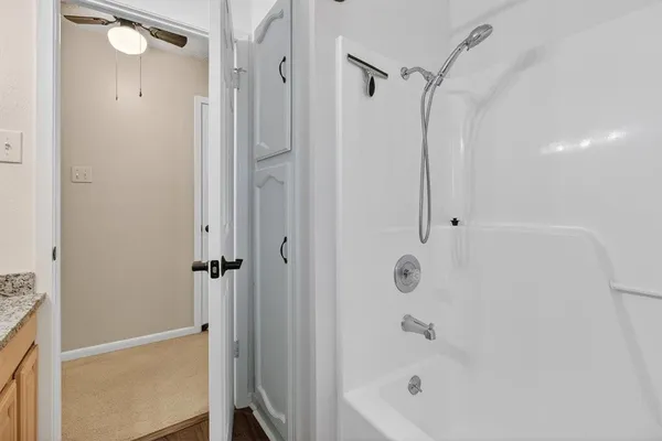 a bathroom with a bathtub and a shower