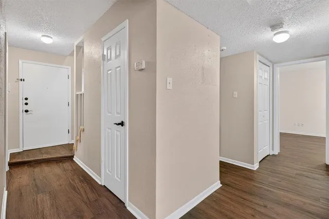a view of hallway with wooden floor
