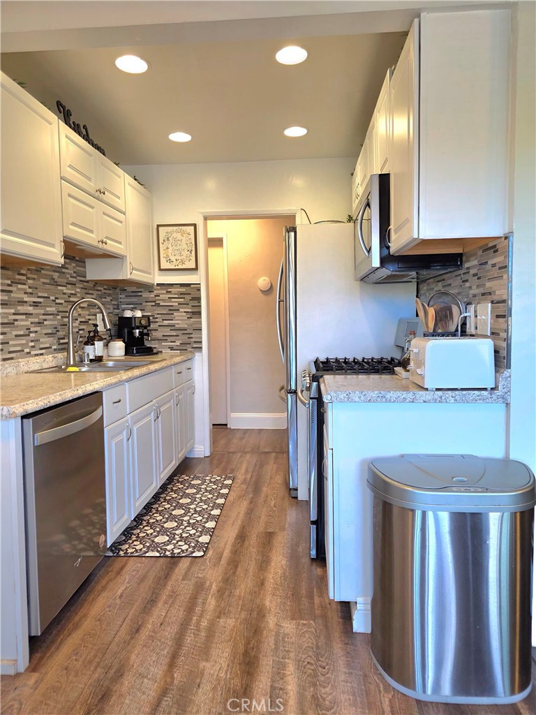 1200 West Lambert Road, Unit 32 La Habra, CA 90631 - Photo 12 of 34 a kitchen with stainless steel appliances granite countertop a stove a sink dishwasher and a refrigerator