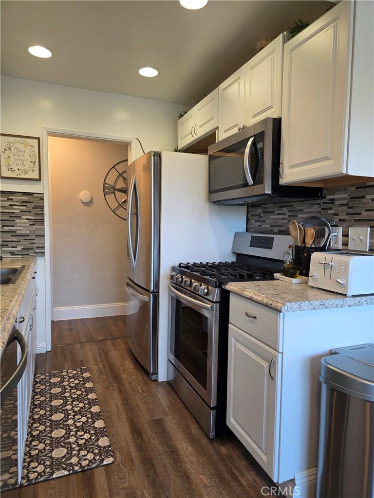 1200 West Lambert Road, Unit 32 La Habra, CA 90631 - Photo 14 of 34 a kitchen with stainless steel appliances granite countertop a stove a refrigerator and a microwave