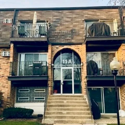 a view of front door of house with stairs