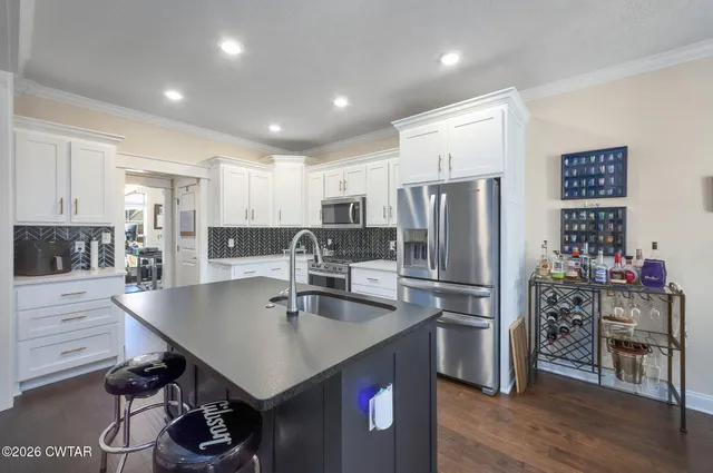 a kitchen with refrigerator and cabinets