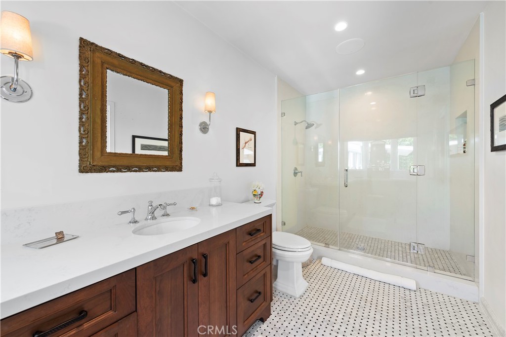 320 Broadway Costa Mesa, CA 92627 - Photo 12 of 25 a bathroom with a double vanity sink mirror double shower and a toilet