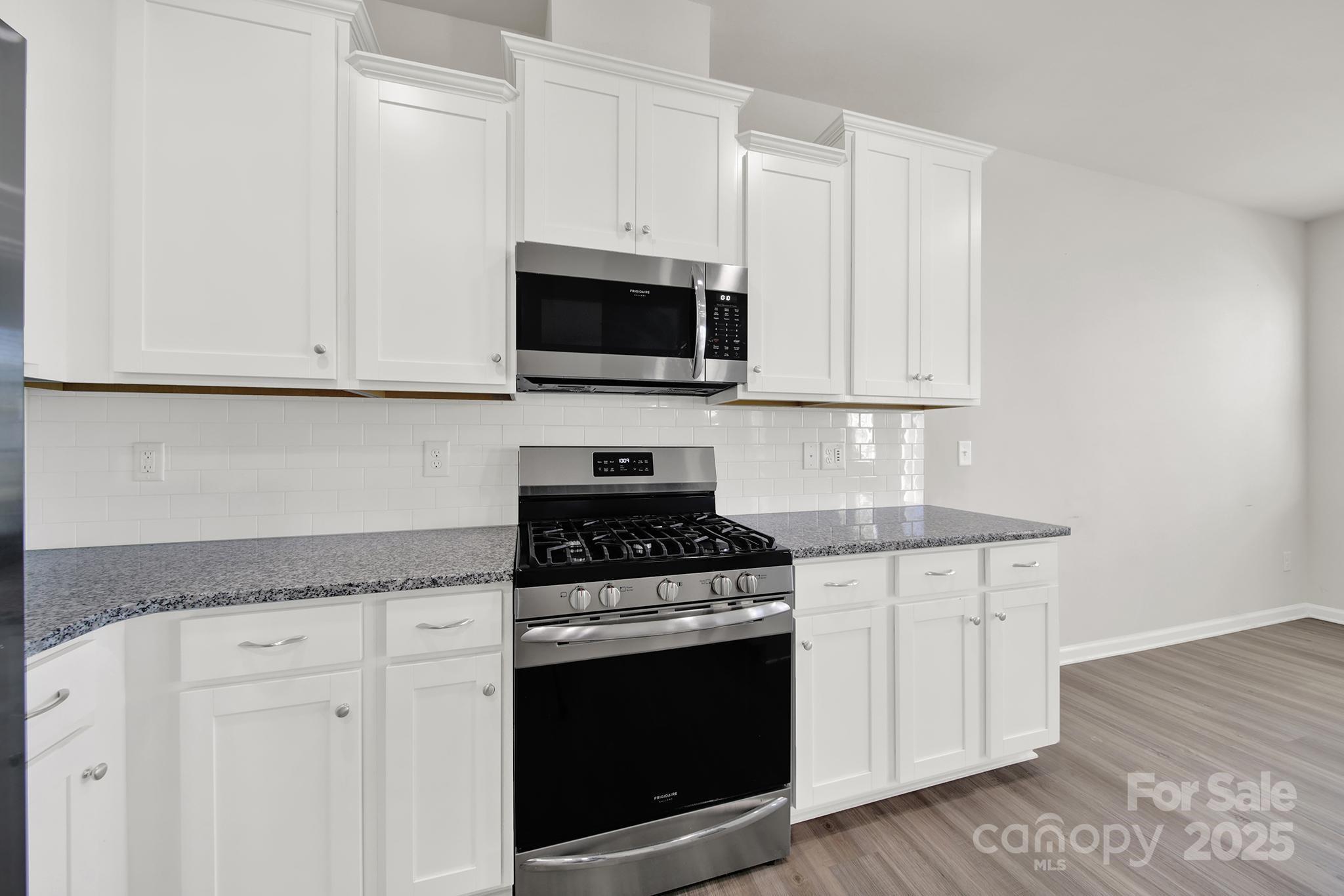 7721 Sea Turtle Way Lancaster, SC 29720 - Photo 15 of 46 a kitchen with granite countertop white cabinets and appliances