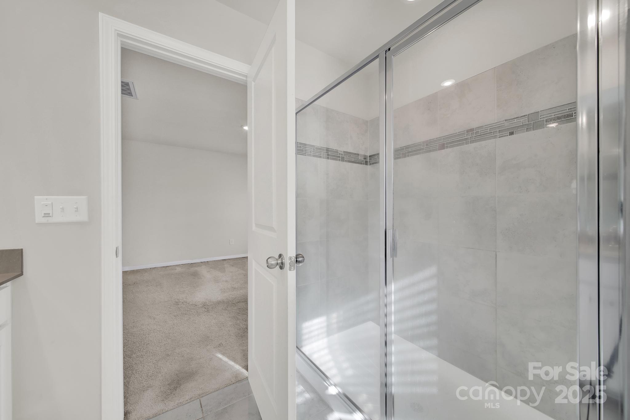 7721 Sea Turtle Way Lancaster, SC 29720 - Photo 23 of 46 a bathroom with a glass shower door
