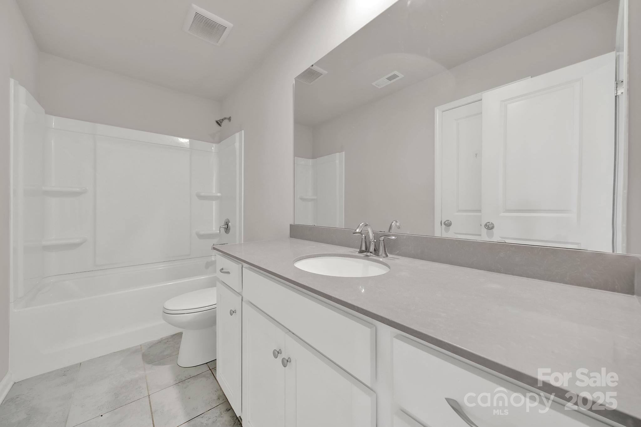 7721 Sea Turtle Way Lancaster, SC 29720 - Photo 26 of 46 a bathroom with a granite countertop sink toilet and shower