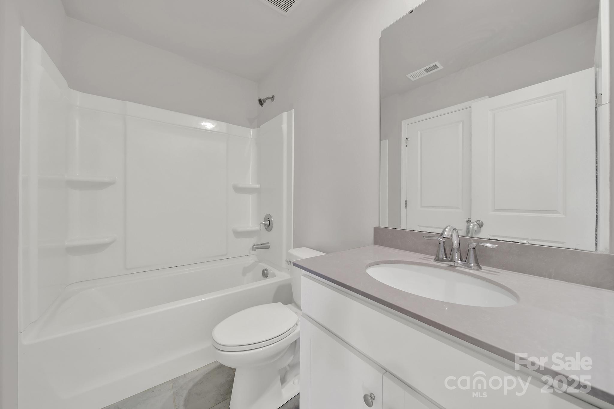 7721 Sea Turtle Way Lancaster, SC 29720 - Photo 31 of 46 a bathroom with a granite countertop sink toilet and shower