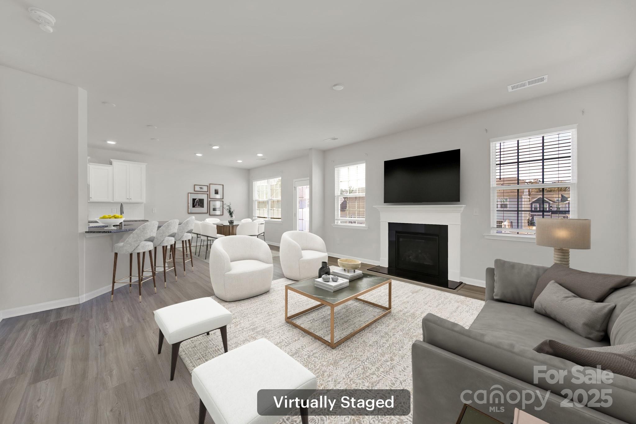 7721 Sea Turtle Way Lancaster, SC 29720 - Photo 7 of 46 a living room with furniture a fireplace and a flat screen tv