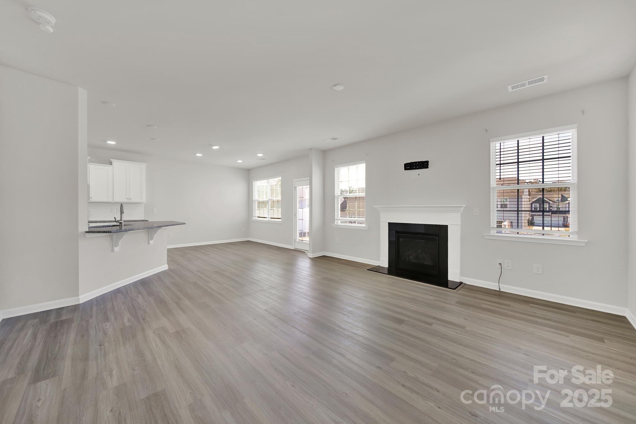 7721 Sea Turtle Way Lancaster, SC 29720 - Photo 8 of 46 a view of an empty room with wooden floor and a window