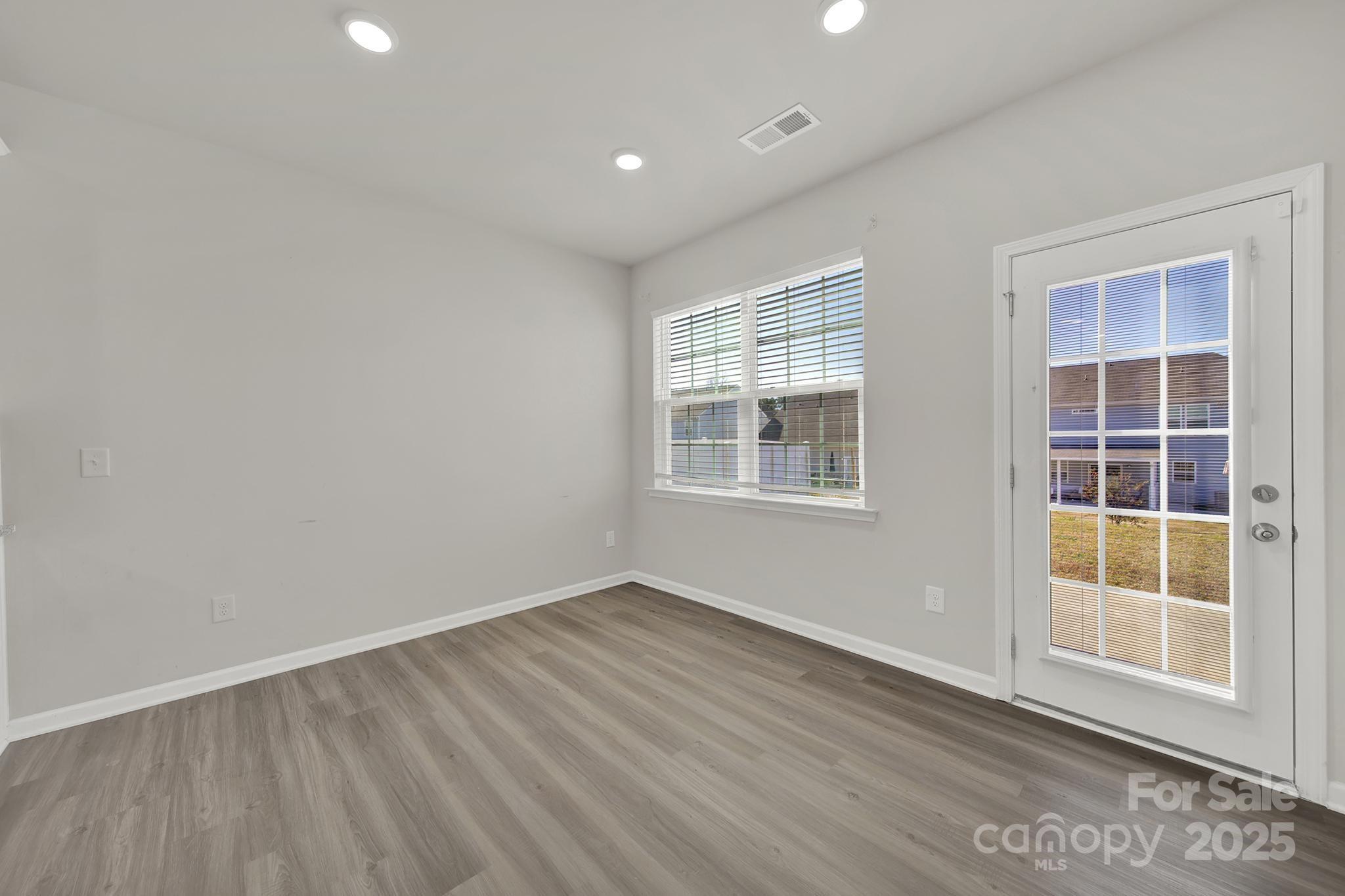 7721 Sea Turtle Way Lancaster, SC 29720 - Photo 10 of 46 an empty room with wooden floor and windows