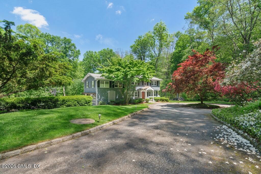 73 Thunder Mountain Road Greenwich, CT 06831 - Photo 4 of 19 a view of a house with a yard and tree s