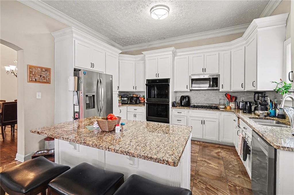 5026 Campbellton Road Southwest Atlanta, GA 30331 - Photo 14 of 39 a kitchen with stainless steel appliances granite countertop a sink refrigerator and microwave