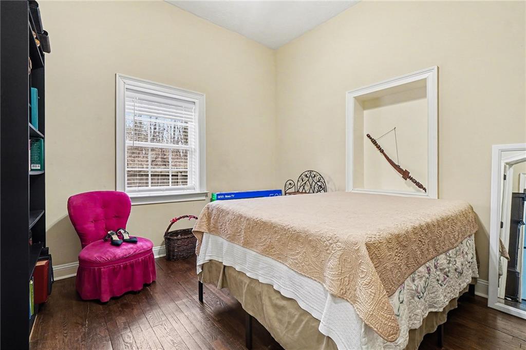 5026 Campbellton Road Southwest Atlanta, GA 30331 - Photo 18 of 39 a bedroom with a bed and wooden floor