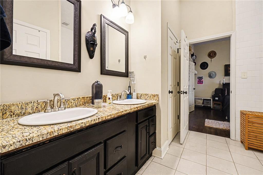 5026 Campbellton Road Southwest Atlanta, GA 30331 - Photo 23 of 39 a spacious bathroom with a granite countertop sink and a mirror