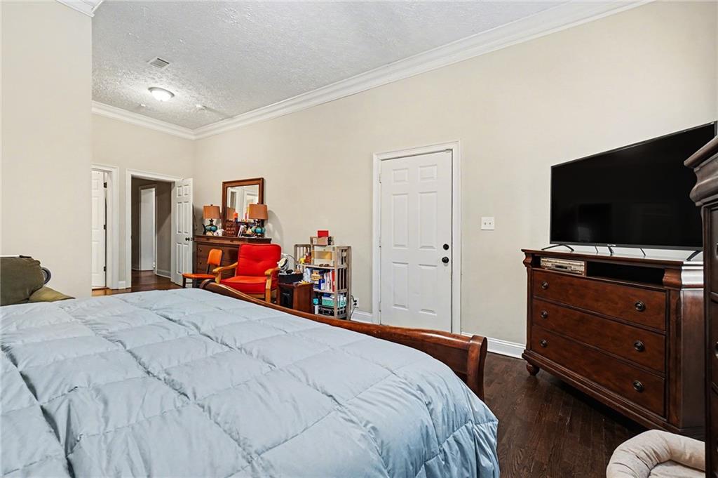 5026 Campbellton Road Southwest Atlanta, GA 30331 - Photo 32 of 39 a bedroom with a bed and a flat tv screen on wall