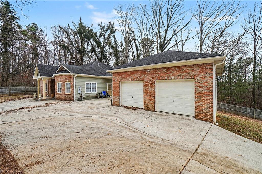 5026 Campbellton Road Southwest Atlanta, GA 30331 - Photo 4 of 39 a front view of a house with a yard and garage