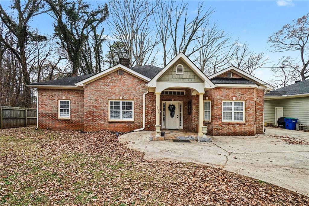 5026 Campbellton Road Southwest Atlanta, GA 30331 - Photo 5 of 39 a front view of a house with a yard and garage