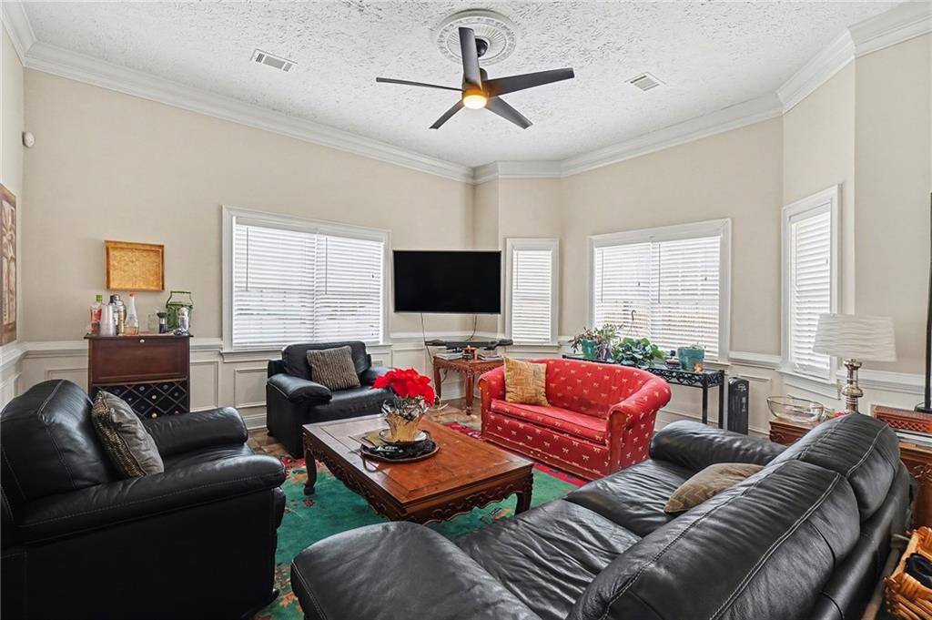 5026 Campbellton Road Southwest Atlanta, GA 30331 - Photo 10 of 39 a living room with furniture a large window and a flat screen tv