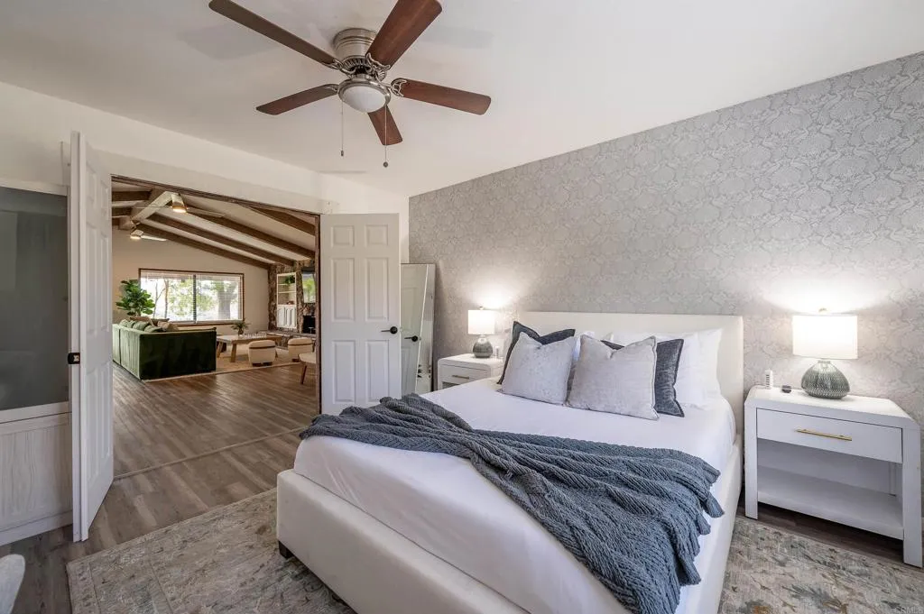 26086 Bear Valley Heights Road Valley Center, CA 92082 - Photo 36 of 65 a spacious bedroom with a bed and a walk in closet