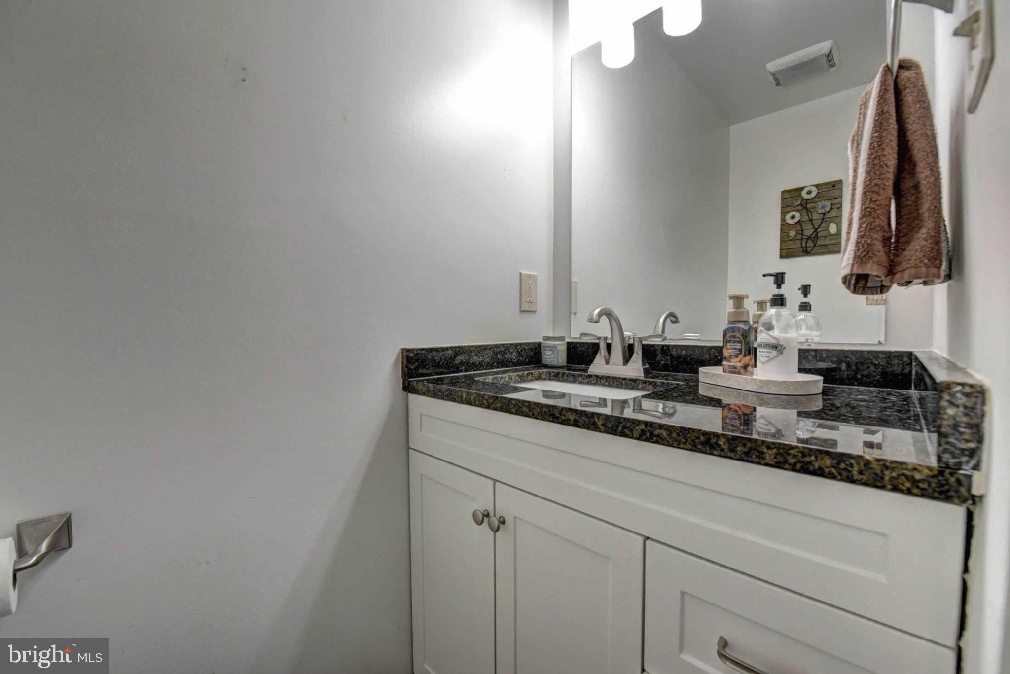 2226 Gunsmith Square Reston, VA 20191 - Photo 15 of 35 a bathroom with a granite countertop sink and a mirror