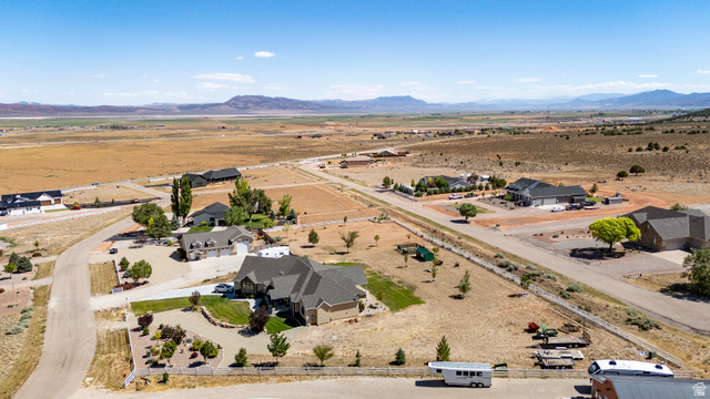 3311 West Allard Summit, UT 84772 - Photo 6 of 97 Expansive property featuring a paved driveway, a manicured lawn area, and established landscaping, surrounded by open terrain and distant mountains