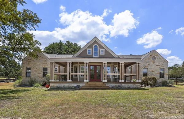 a view of a house with swimming pool and a yard