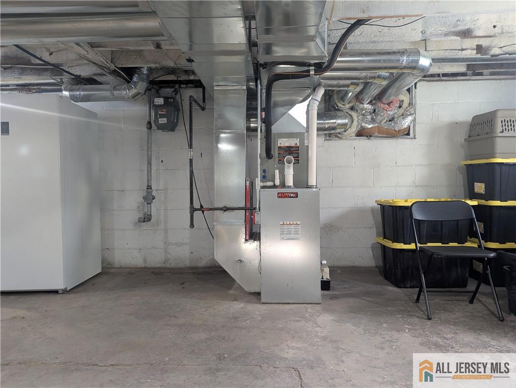 220 1st Street Dunellen, NJ 08812 - Photo 19 of 23 a view of storage and utility room with racks
