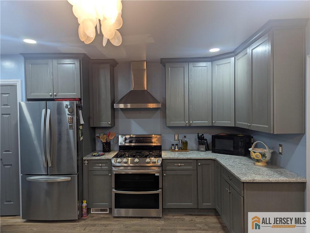 220 1st Street Dunellen, NJ 08812 - Photo 7 of 23 a kitchen with stainless steel appliances granite countertop a stove a refrigerator and a sink