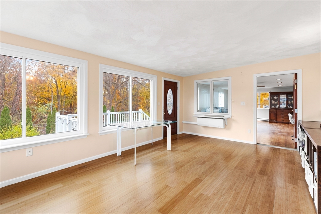 10 Apache Trail Medford, MA 02155 - Photo 17 of 41 an empty room with wooden floor and windows