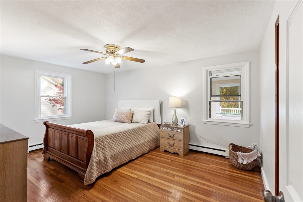 10 Apache Trail Medford, MA 02155 - Photo 19 of 41 a bedroom with a bed and a chandelier