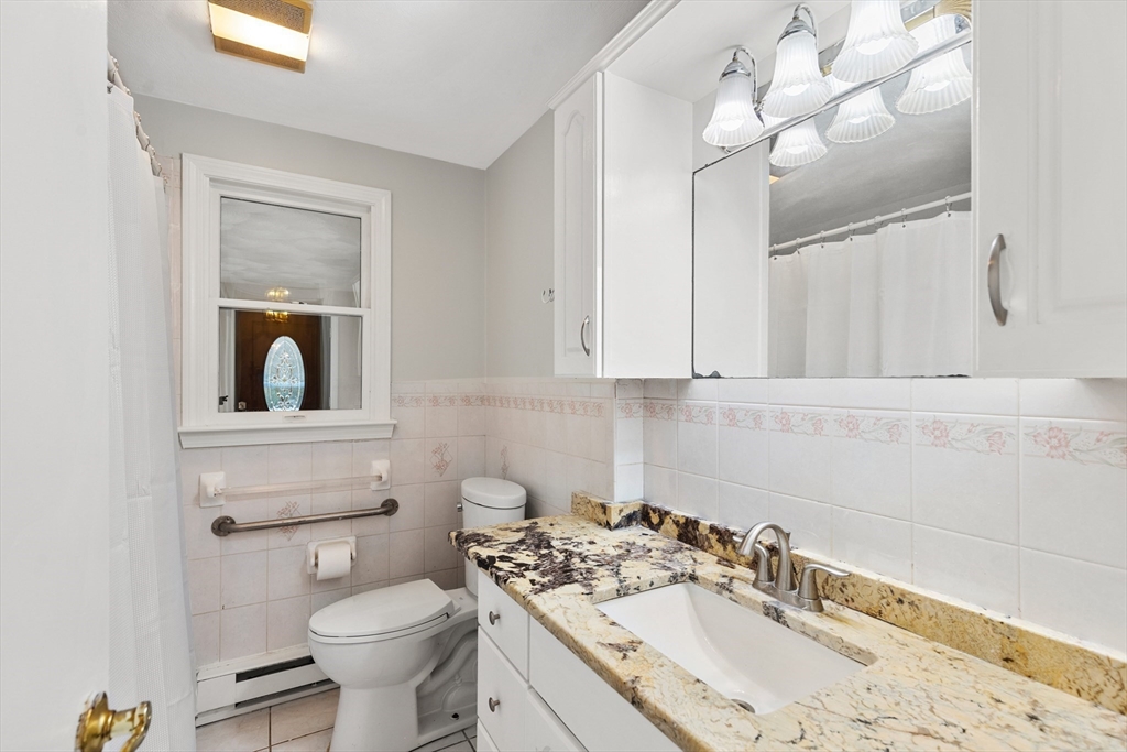 10 Apache Trail Medford, MA 02155 - Photo 20 of 41 a bathroom with a sink a toilet and mirror