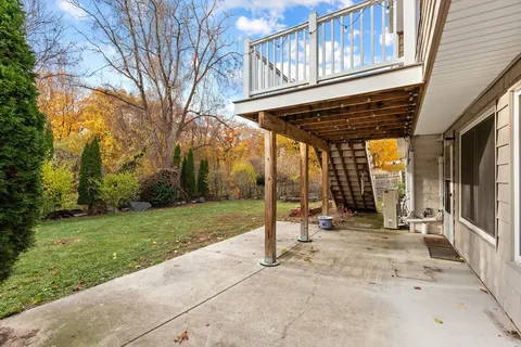 a view of a house with backyard and wooden fence