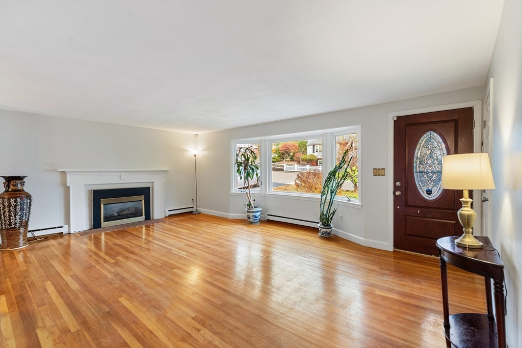 10 Apache Trail Medford, MA 02155 - Photo 4 of 41 a view of a livingroom with wooden floor and a fireplace