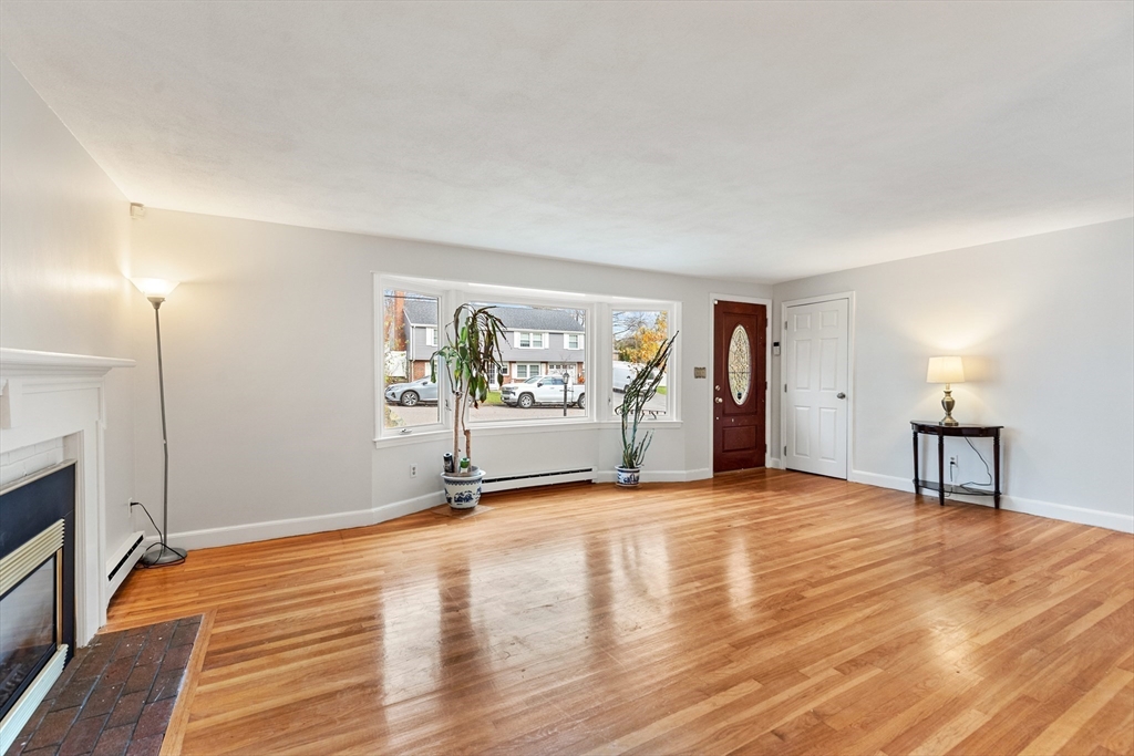 10 Apache Trail Medford, MA 02155 - Photo 5 of 41 a view of an empty room with window and wooden floor