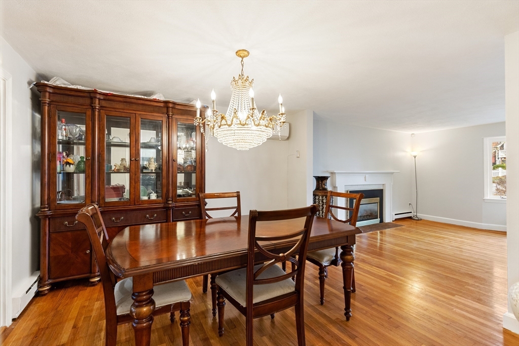10 Apache Trail Medford, MA 02155 - Photo 9 of 41 a dining room with furniture a chandelier and wooden floor
