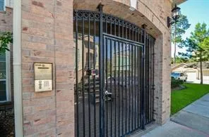 a view of a brick house with large windows
