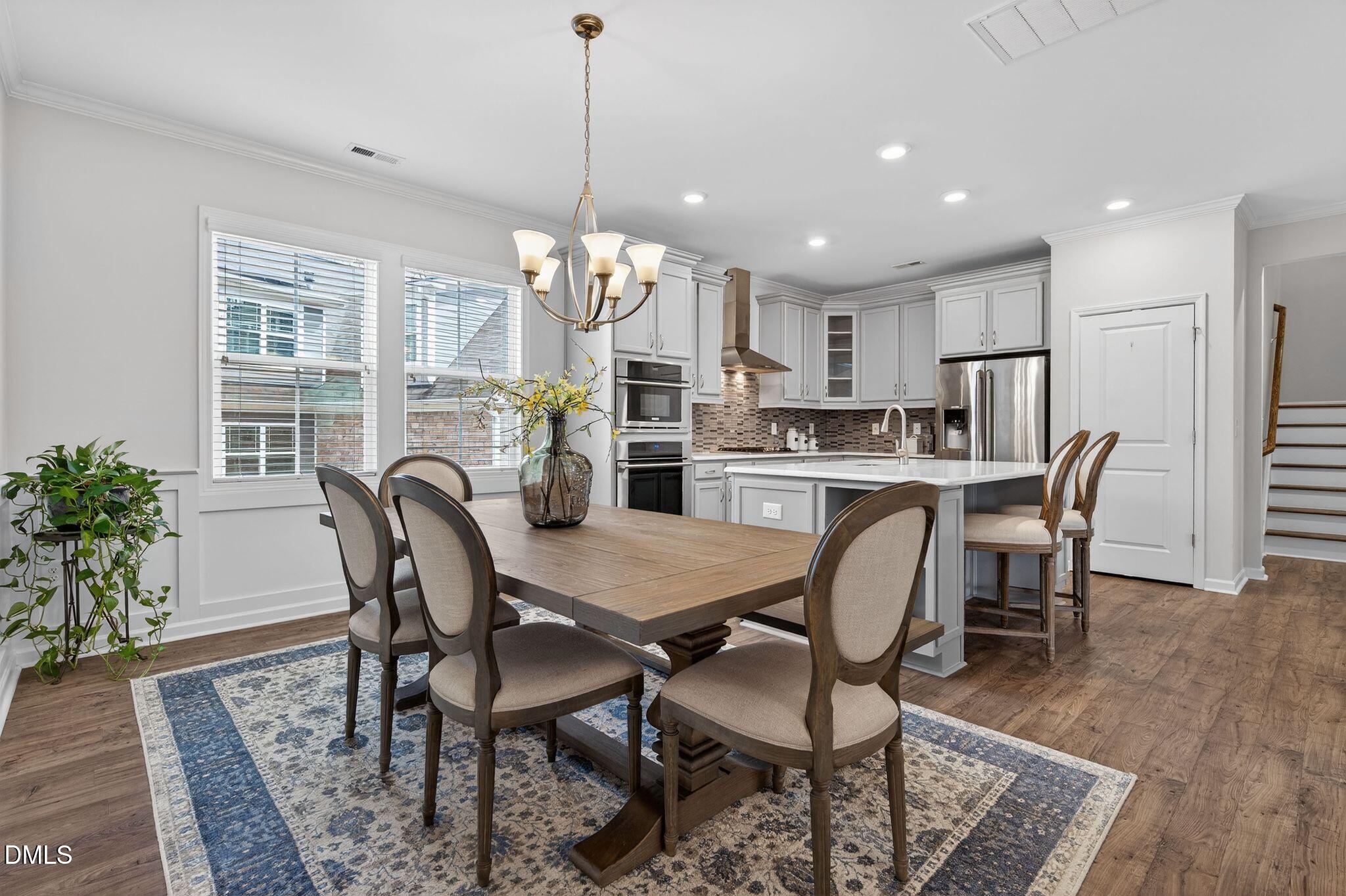 528 Spring Flower Court Cary, NC 27511 - Photo 14 of 51 a view of a dining room with furniture window and wooden floor
