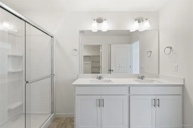 a bathroom with a sink vanity and a mirror