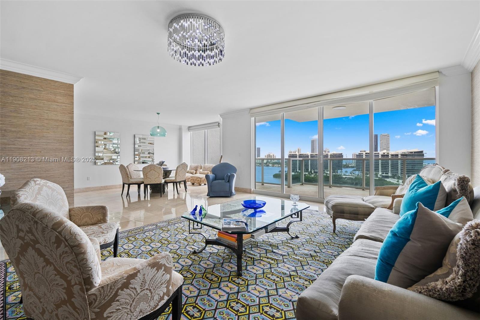 a living room with furniture a rug and a floor to ceiling window