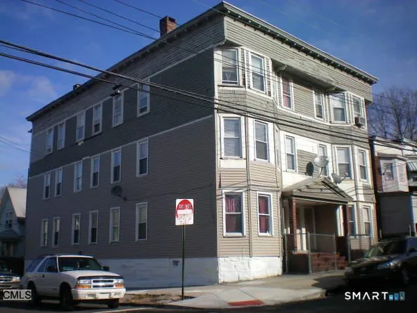 a front view of a residential apartment building with a street
