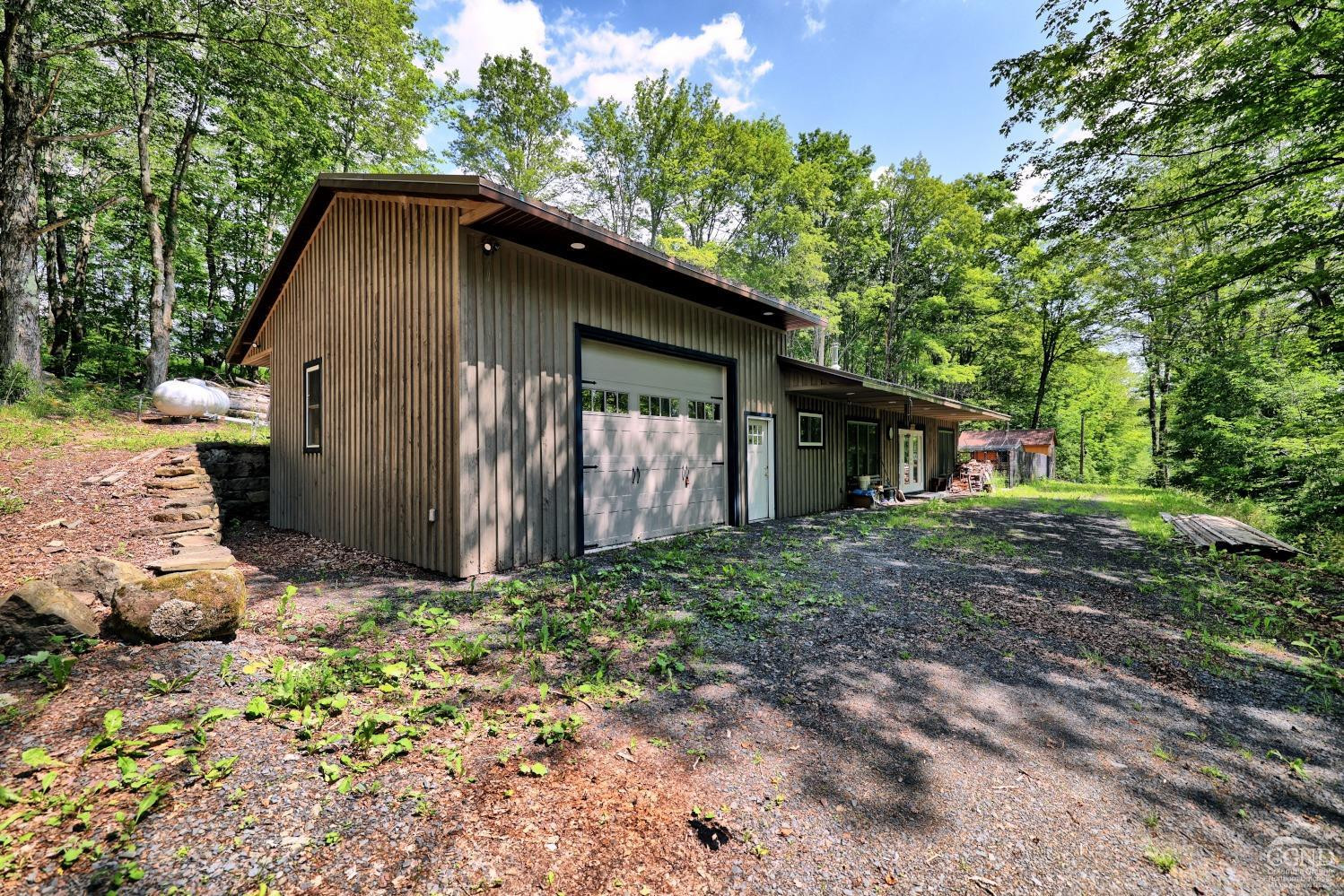 195 Gulf Rd Extension Rensselaerville, NY 12147 - Photo 54 of 57 a view of a house with a yard and large tree