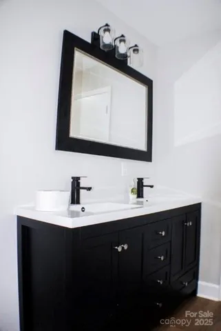 a bathroom with a sink vanity and mirror