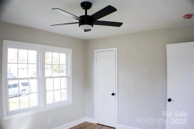 a view of a livingroom with a window and a ceiling fan