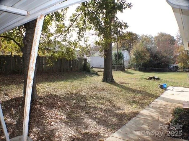 a view of a backyard with large tree