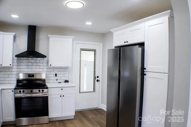 a kitchen with stainless steel appliances a refrigerator stove and sink